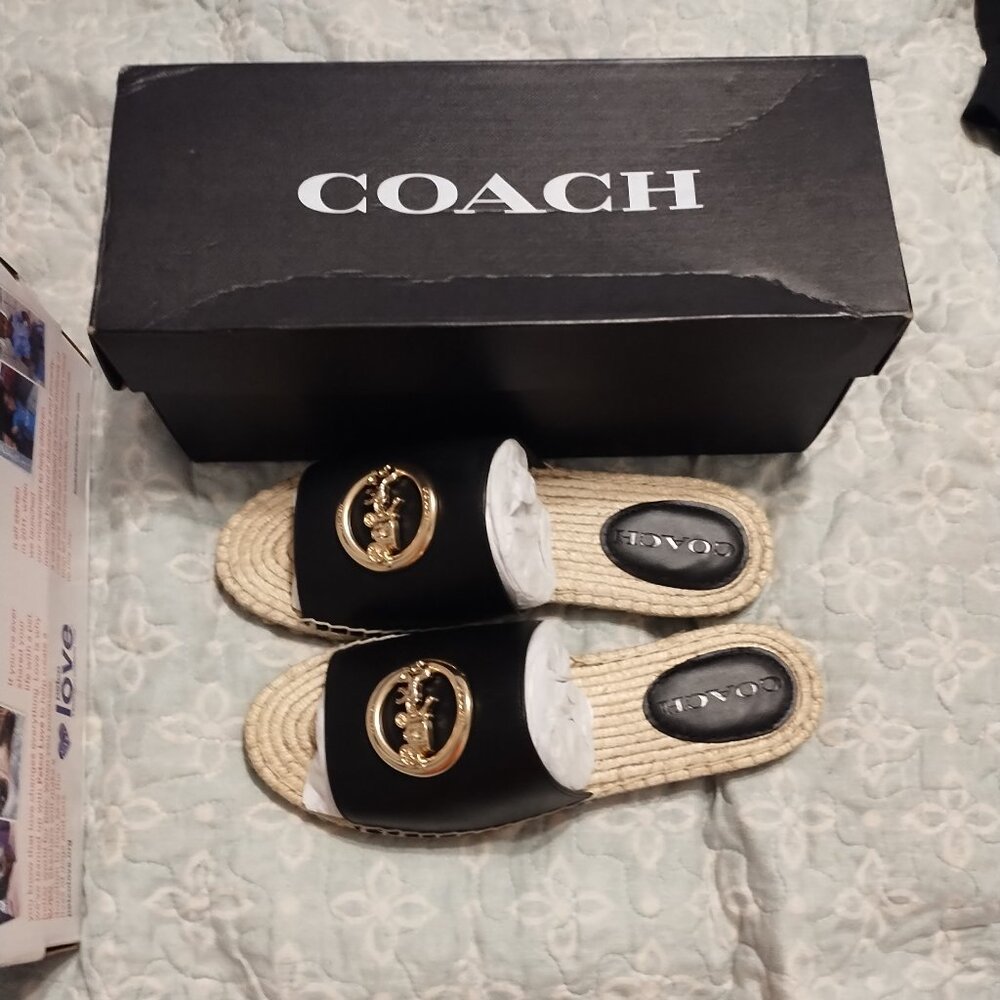 New with tag Coach black leather with gold pendant flat sandals